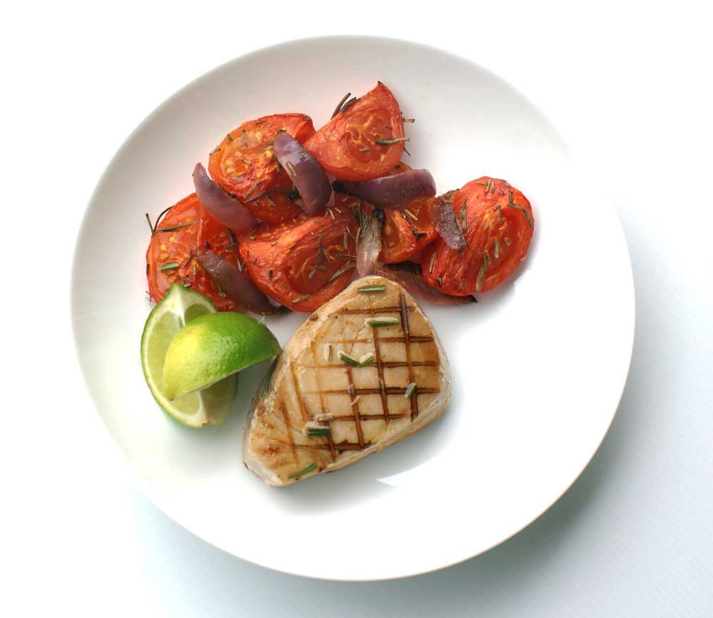 Seared Tuna with Roasted Rosemary Tomatoes - recipe. Rosemary, lime and garlic are used to marinate the fresh tuna, served with sweet roasted tomatoes