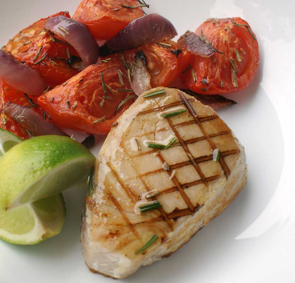 Seared Tuna with Roasted Rosemary Tomatoes - recipe. Rosemary, lime and garlic are used to marinate the fresh tuna, served with sweet roasted tomatoes