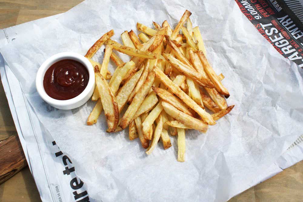Crispy Oven Baked Fries. The potatoes are oven cooked in coconut oil, making them a healthy side dish.