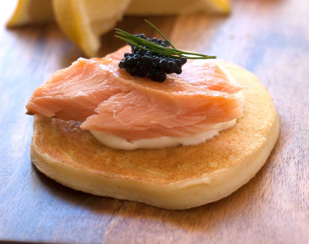Deliciously light ricotta pancakes, topped with hot smoked salmon and sour cream. A great appetiser that you can prepare in advance. Perfect for the holidays #Christmas #food #recipe