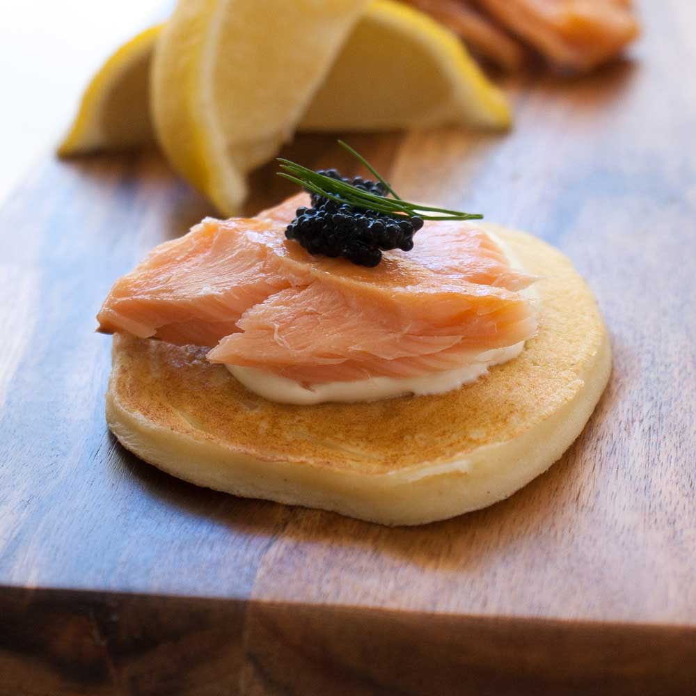 Deliciously light ricotta pancakes, topped with hot smoked salmon and sour cream. A great appetiser that you can prepare in advance. Perfect for the holidays #Christmas #food #recipe