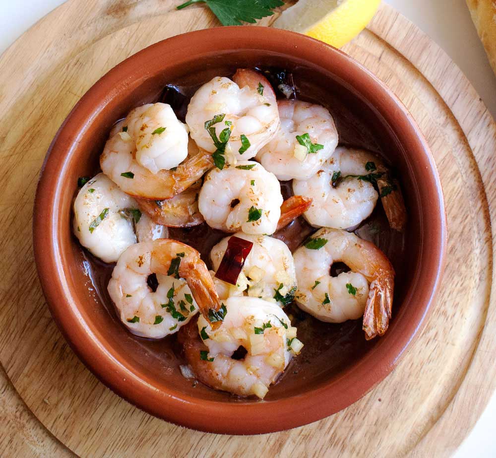 Gambas Pil Pil. A delicious dish of prawns (shrimps) in a wonderful garlic and chilli olive oil. Perfect tapas.