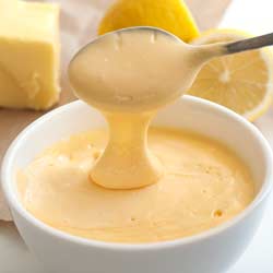 Small square picture of a spoon scooping up easy hollandaise sauce.