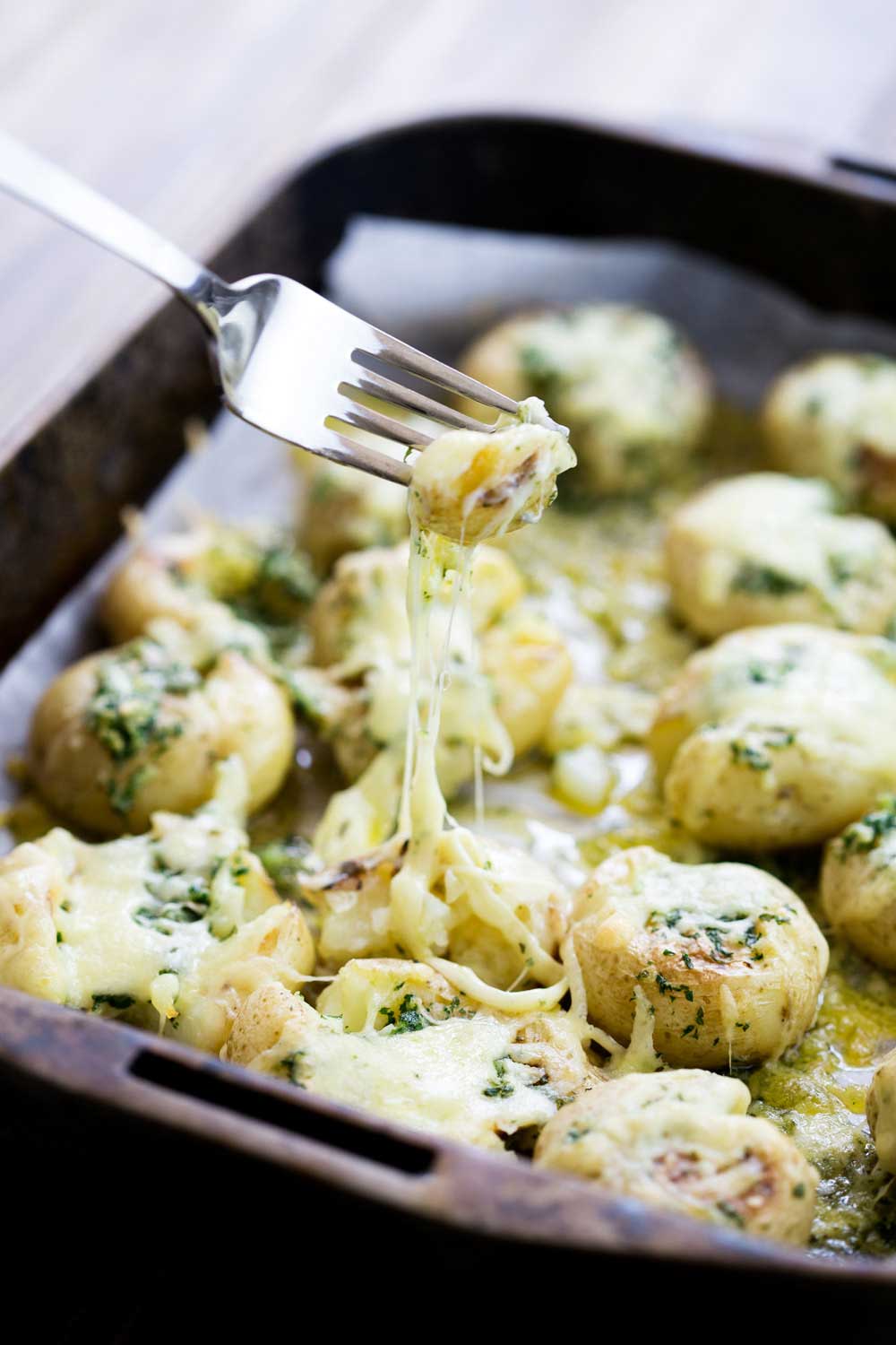 Cheesy Garlic Butter Potatoes. Soft fluffy potatoes with a light crunch, rich with garlic butter and then coated generously in melted oozy cheese. | Sprinkles and Sprouts