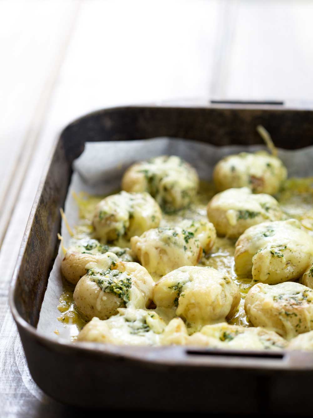 Cheesy Garlic Butter Potatoes. Soft fluffy potatoes with a light crunch, rich with garlic butter and then coated generously in melted oozy cheese. | Sprinkles and Sprouts