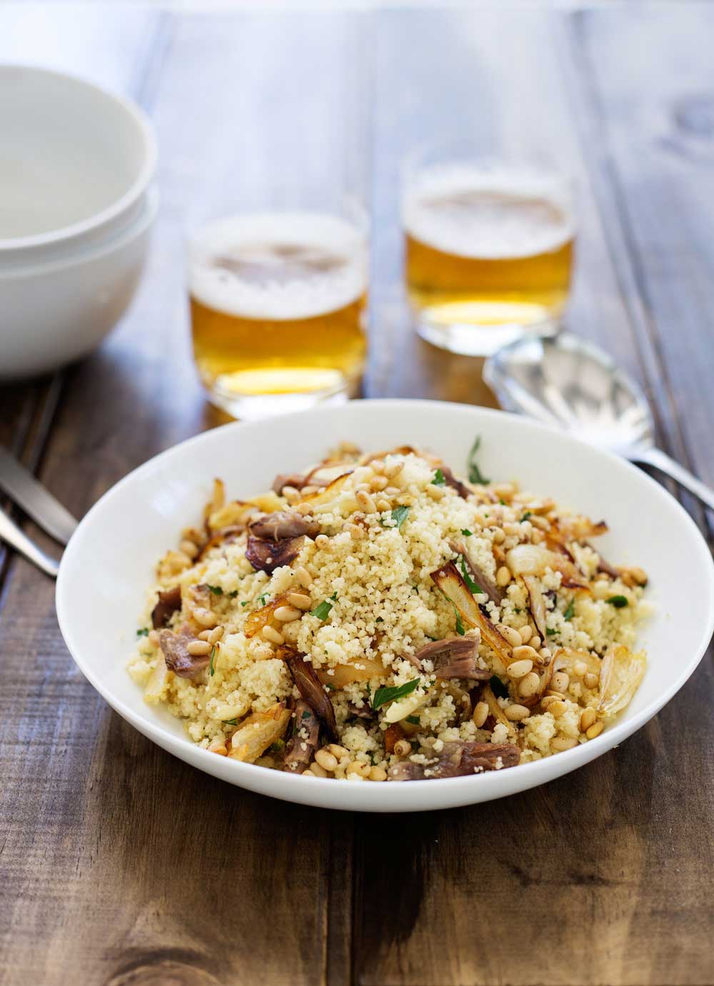 Warm lamb, sweet sticky onions, crunchy buttery pine nuts and fresh parsley all stirred through soft fluffy couscous. This meal is comforting but in no way boring! Eaten by the spoonful with a cold beer it is the perfect easy to eat dinner. Sit down on the sofa, find something good to watch and spoon it into your mouth. Yum! | Sprinkles and Sprouts