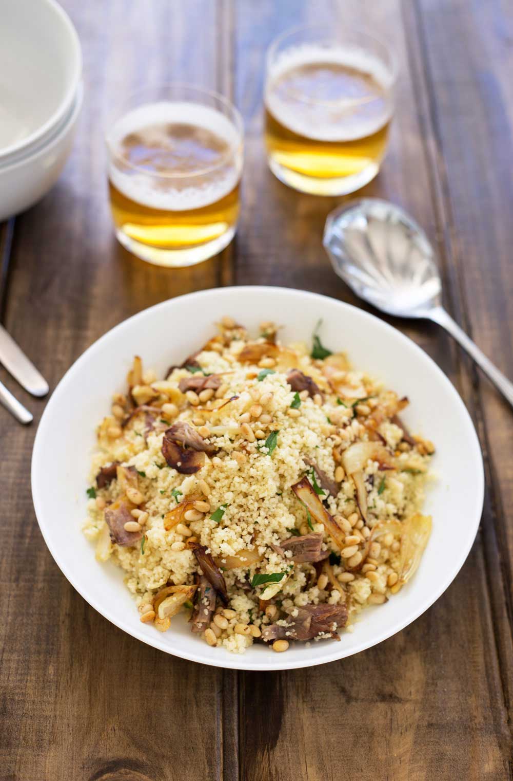Warm lamb, sweet sticky onions, crunchy buttery pine nuts and fresh parsley all stirred through soft fluffy couscous. This meal is comforting but in no way boring! Eaten by the spoonful with a cold beer it is the perfect easy to eat dinner. Sit down on the sofa, find something good to watch and spoon it into your mouth. Yum! | Sprinkles and Sprouts