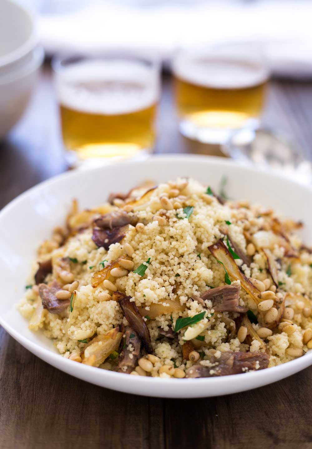Warm lamb, sweet sticky onions, crunchy buttery pine nuts and fresh parsley all stirred through soft fluffy couscous. This meal is comforting but in no way boring! Eaten by the spoonful with a cold beer it is the perfect easy to eat dinner. Sit down on the sofa, find something good to watch and spoon it into your mouth. Yum! | Sprinkles and Sprouts