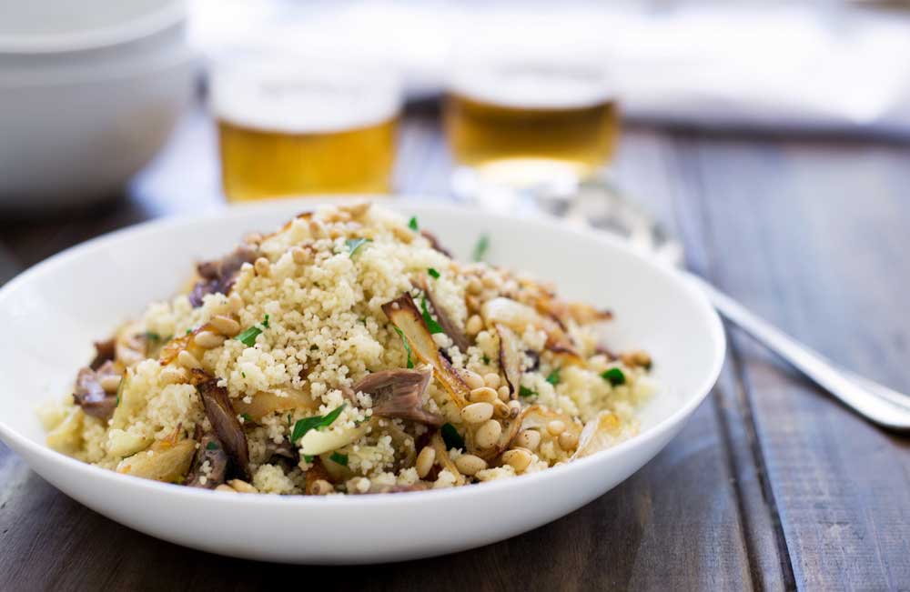 Warm lamb, sweet sticky onions, crunchy buttery pine nuts and fresh parsley all stirred through soft fluffy couscous. This meal is comforting but in no way boring! Eaten by the spoonful with a cold beer it is the perfect easy to eat dinner. Sit down on the sofa, find something good to watch and spoon it into your mouth. Yum! | Sprinkles and Sprouts