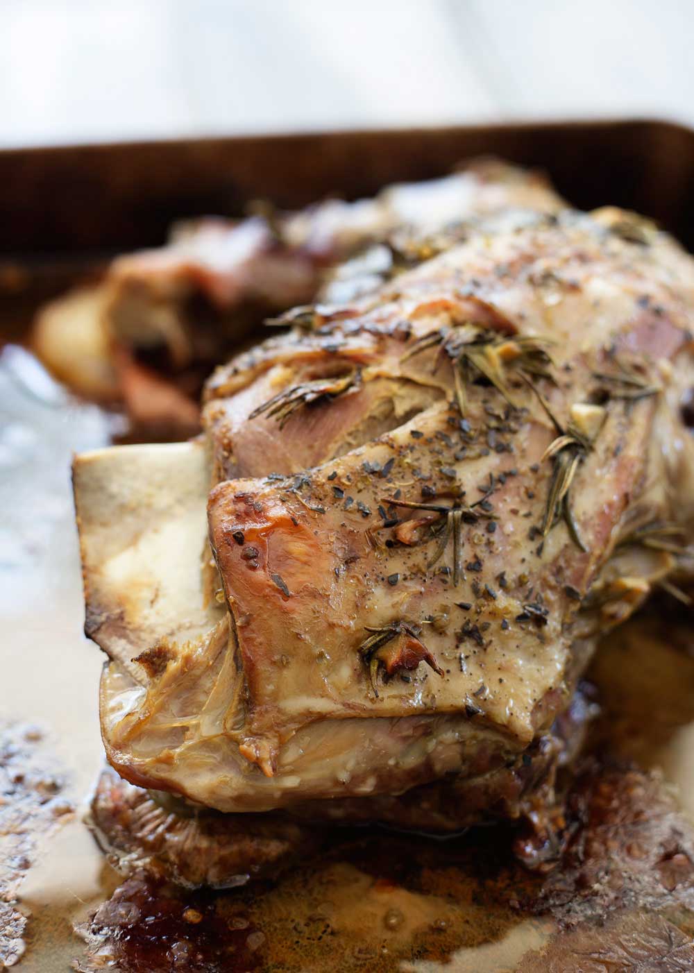 Slow Roasted Lamb with Anchovy and Rosemary. There is a touch of the Greek about this melt-in-the-mouth lamb dish. Succulent, juicy lamb with a rich flavour and a wonderful depth from the rosemary, anchovy and garlic. | Sprinkles and Sprouts