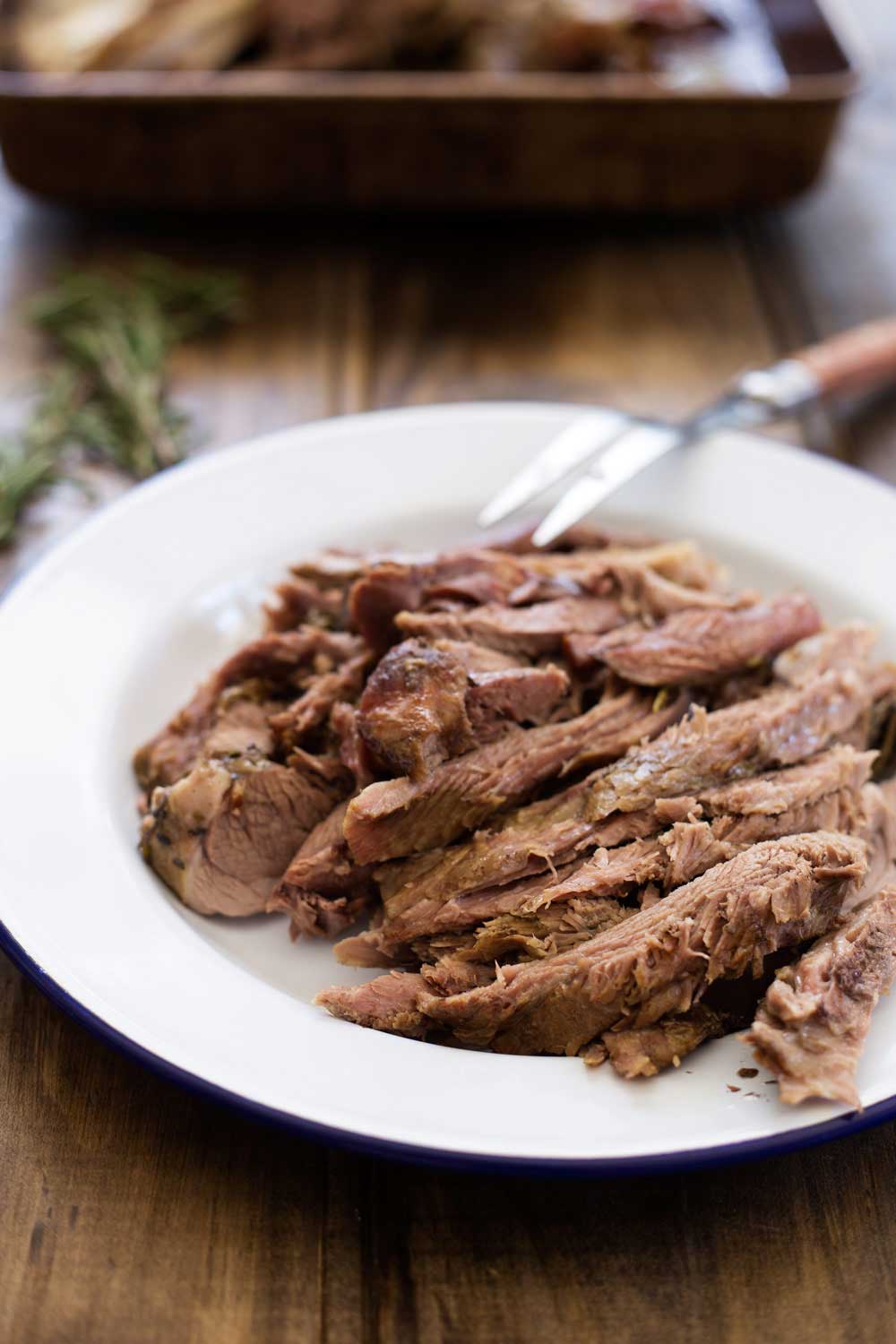 Slow Roasted Lamb with Anchovy and Rosemary. There is a touch of the Greek about this melt-in-the-mouth lamb dish. Succulent, juicy lamb with a rich flavour and a wonderful depth from the rosemary, anchovy and garlic. | Sprinkles and Sprouts