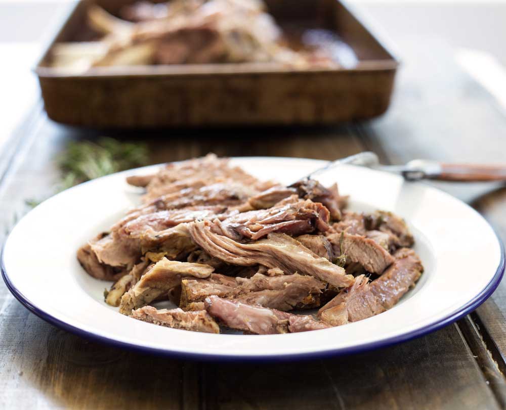 Slow Roasted Lamb with Anchovy and Rosemary. There is a touch of the Greek about this melt-in-the-mouth lamb dish. Succulent, juicy lamb with a rich flavour and a wonderful depth from the rosemary, anchovy and garlic. | Sprinkles and Sprouts