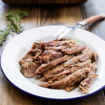 Slow Roasted Lamb with Anchovy and Rosemary. There is a touch of the Greek about this melt-in-the-mouth lamb dish. Succulent, juicy lamb with a rich flavour and a wonderful depth from the rosemary, anchovy and garlic. | Sprinkles and Sprouts