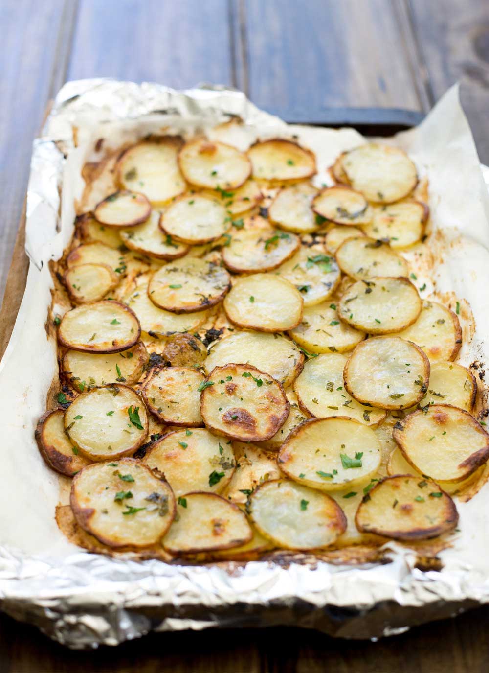 Delicious disks of potato, roasted until they are golden brown and soft inside. Sprinkled with salt, pepper and fresh parsley these are the perfect side or appetiser | Sprinkles and Sprouts