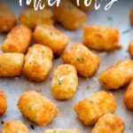 Pin Image: Homemade potato tots on a lined tray with text overlaid