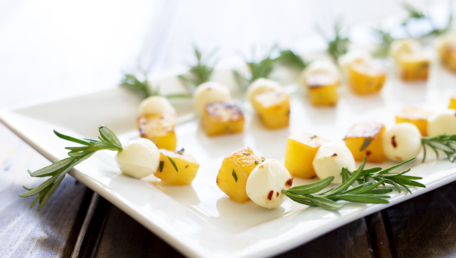 Side view of the rosemary skewers showing the charred pineapple