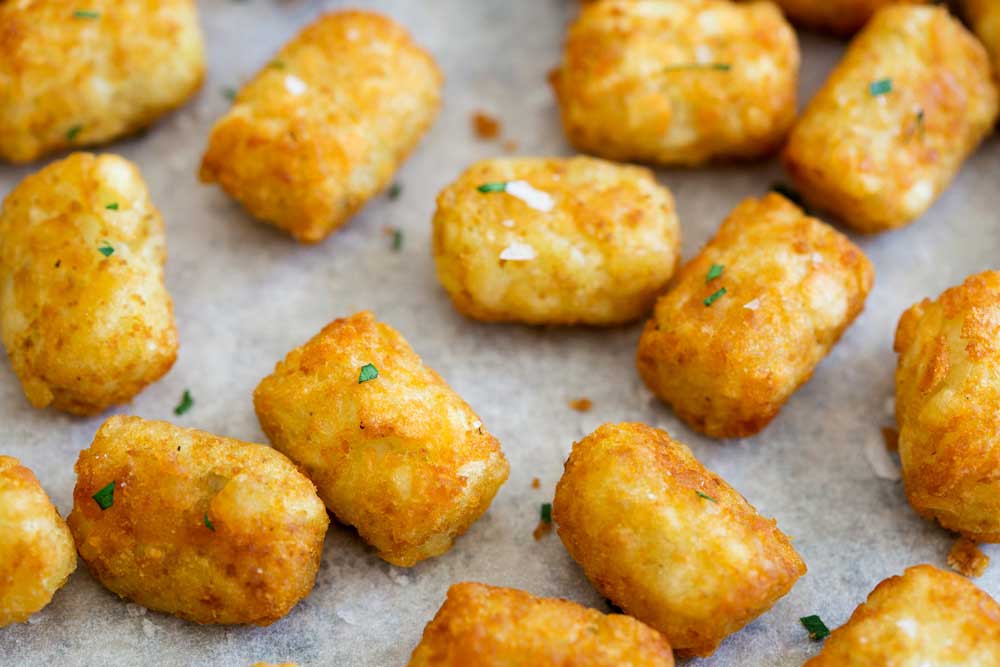 Homemade potato tots, shredded potato, cooked until crisp on the outside and fluffy inside. These homemade potato tots have just 4 ingredients (well 5 if you count salt) and are super simple to make. And keep reading for the best part of this whole recipe!!!