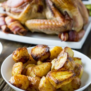 Crispy fluffy roast potatoes that you can prepare a week before Christmas! That is a winner in my book!!! No peeling potatoes on Christmas morning means more time to sip bucks fizz and enjoy watching people open presents.