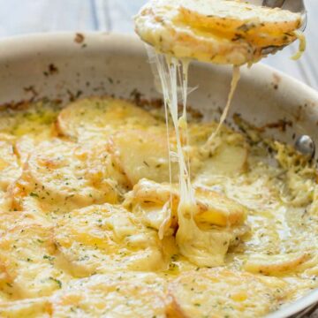 Cheesy Layered Potatoes. Potatoes, cream and cheese. Seriously what could be better? Layers of potato and onion cooked in cream and stock until tender and then smothered in cheese and baked to a melty, creamy perfection. This is comfort food at it's very best! | Sprinkles and Sprouts