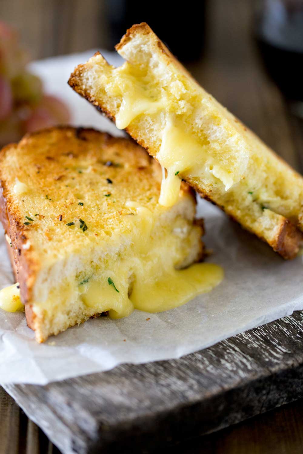 Cheesy garlic bread sandwiches. Garlic butter smothered bread filled with soft brie, crisped and browned to melting gooey perfection. Perfection! I kid you not, this is a sandwich that will make you lick the plate!!! 