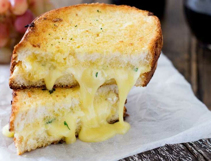Cheesy garlic bread sandwiches. Garlic butter smothered bread filled with soft brie, crisped and browned to melting gooey perfection. Perfection! I kid you not, this is a sandwich that will make you lick the plate!!!