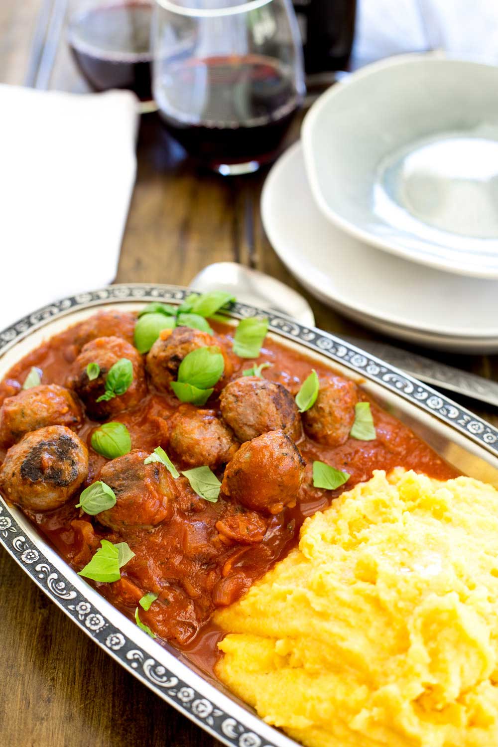 Soft, light, juicy baked Italian meatballs, baked in a rich tomato sauce and served with soft cheesy polenta. This is comfort food at it's very best. The meatballs are so tender and packed full of flavour!