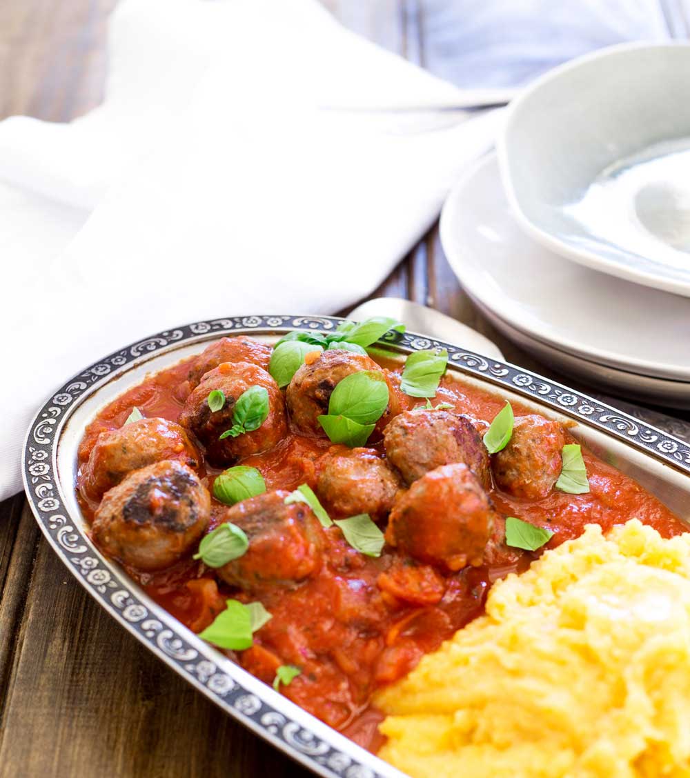 Soft, light, juicy baked Italian meatballs, baked in a rich tomato sauce and served with soft cheesy polenta. This is comfort food at it's very best. The meatballs are so tender and packed full of flavour!