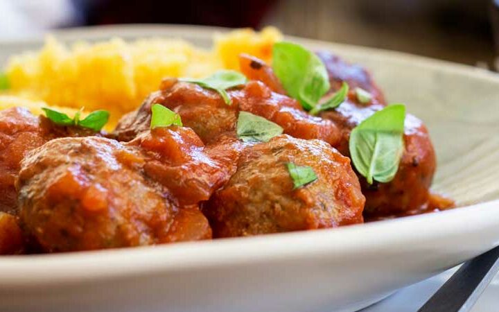 Soft, light, juicy baked Italian meatballs, baked in a rich tomato sauce and served with soft cheesy polenta. This is comfort food at it's very best. The meatballs are so tender and packed full of flavour!