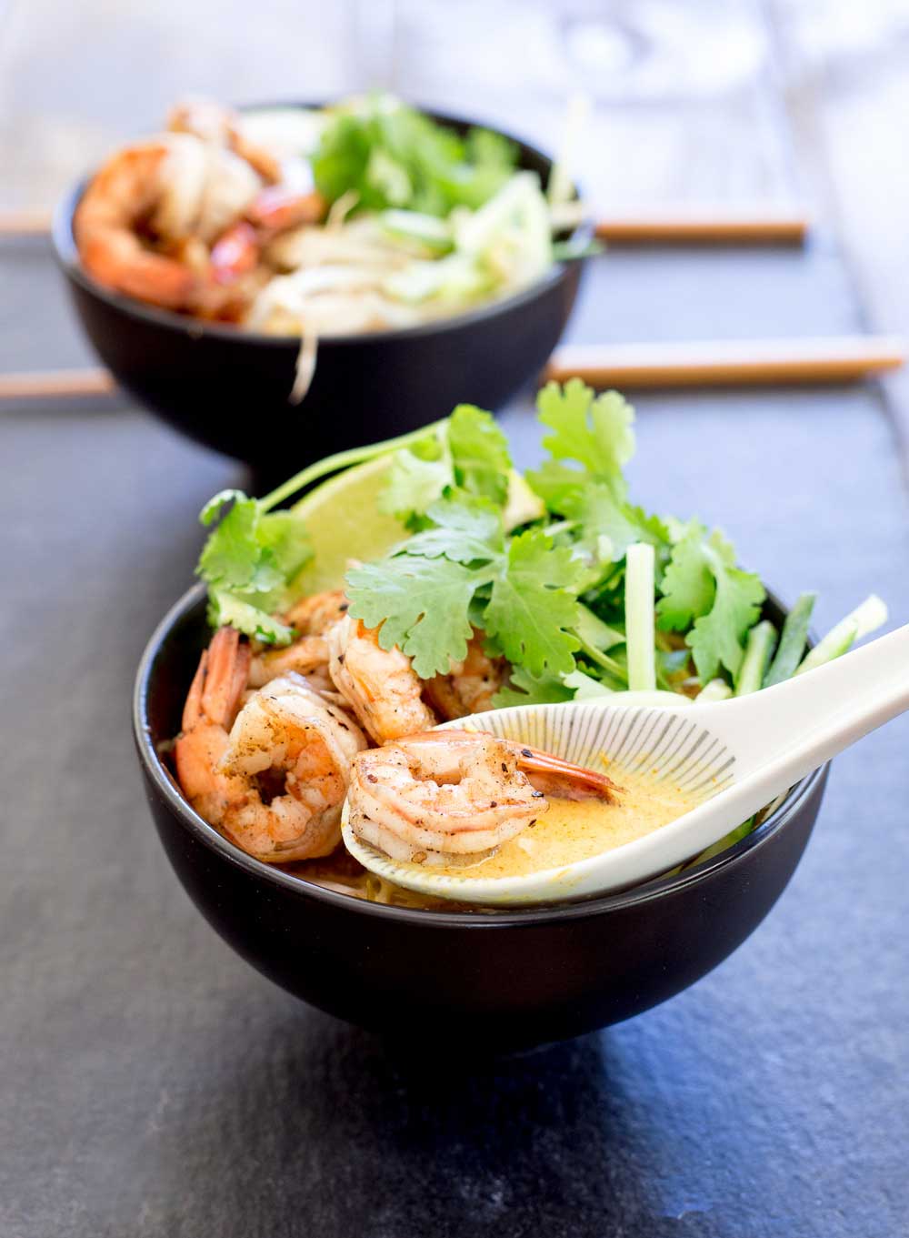 Spiced prawns, a rich spicy coconut broth, ramen noodles, fresh beansprouts and shredded cucumber. Grab some bowls, fill them and slurp up this delicious soup. The slurping is mandatory as it makes it taste better!