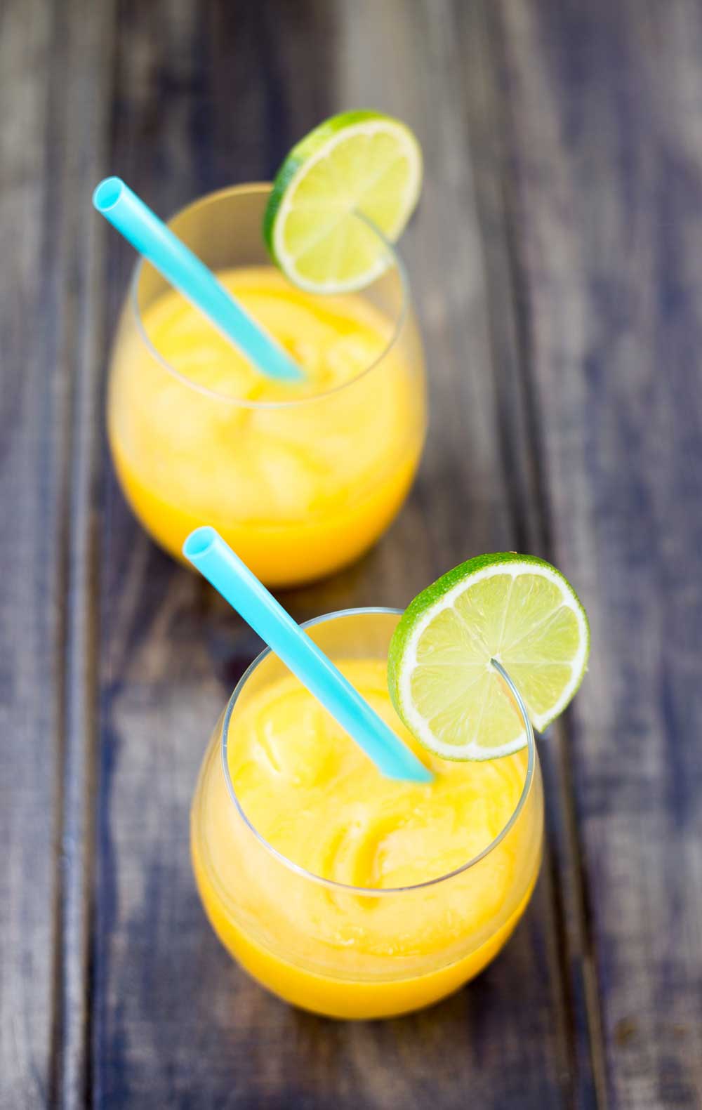 Juicy mango, a hint of lime and a shot of vodka. Simple, cooling and delicious.....also known as Slush puppies or Slurpees for adults :-)
