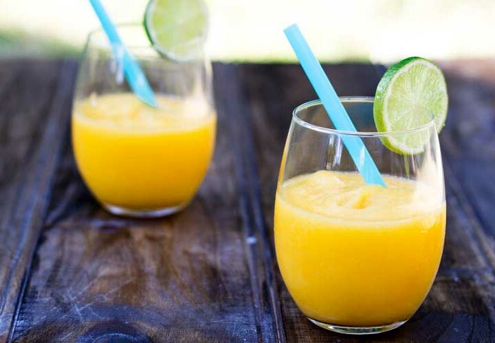 Juicy mango, a hint of lime and a shot of vodka. Simple, cooling and delicious.....also known as Slush puppies or Slurpees for adults :-)