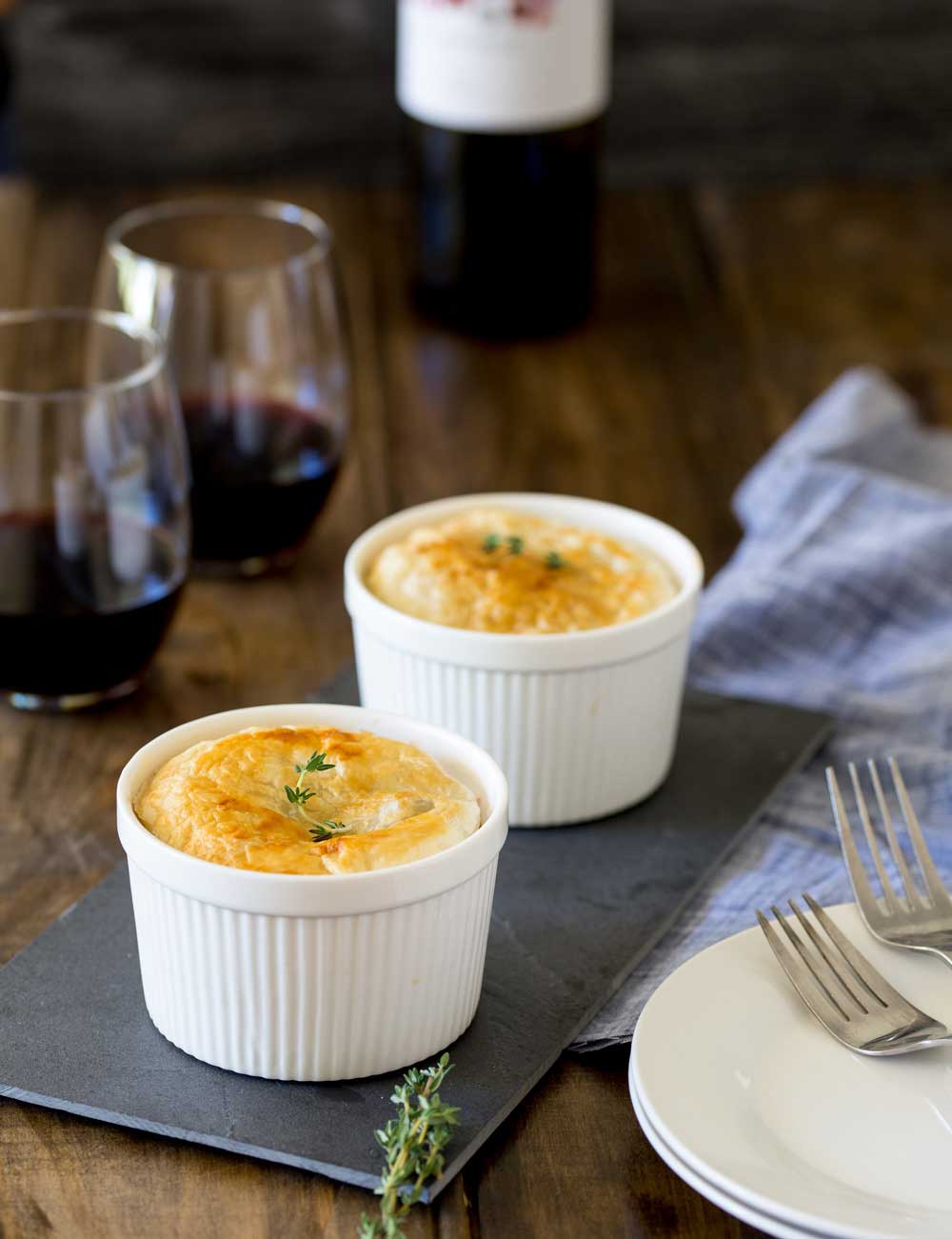 Meaty sausages, hearty lentils, fragrant thyme and rich red wine. All cooked together and covered with a disk of buttery puff pastry. This sausage and lentil pot pie is comfort in a bowl!