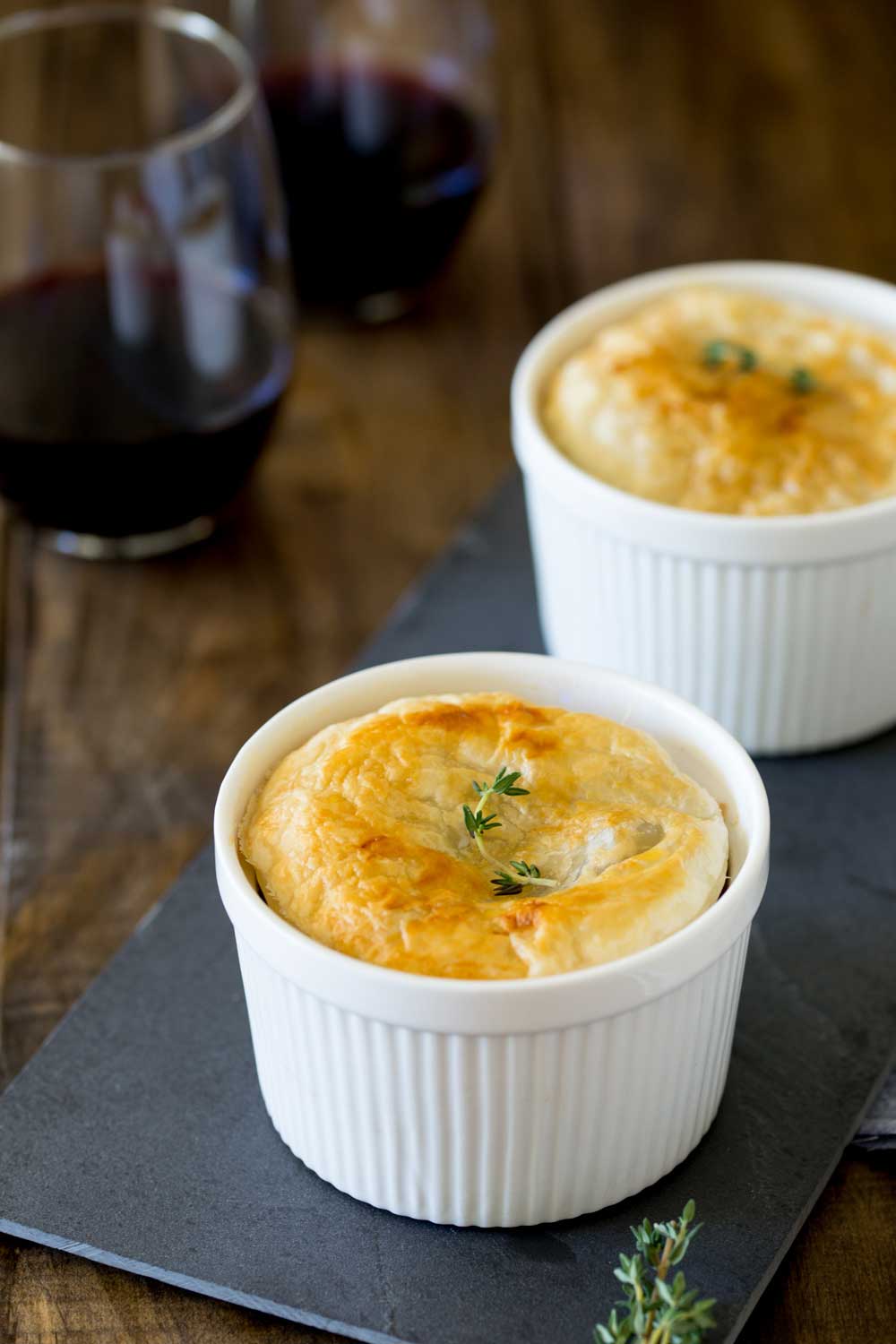Meaty sausages, hearty lentils, fragrant thyme and rich red wine. All cooked together and covered with a disk of buttery puff pastry. This sausage and lentil pot pie is comfort in a bowl!
