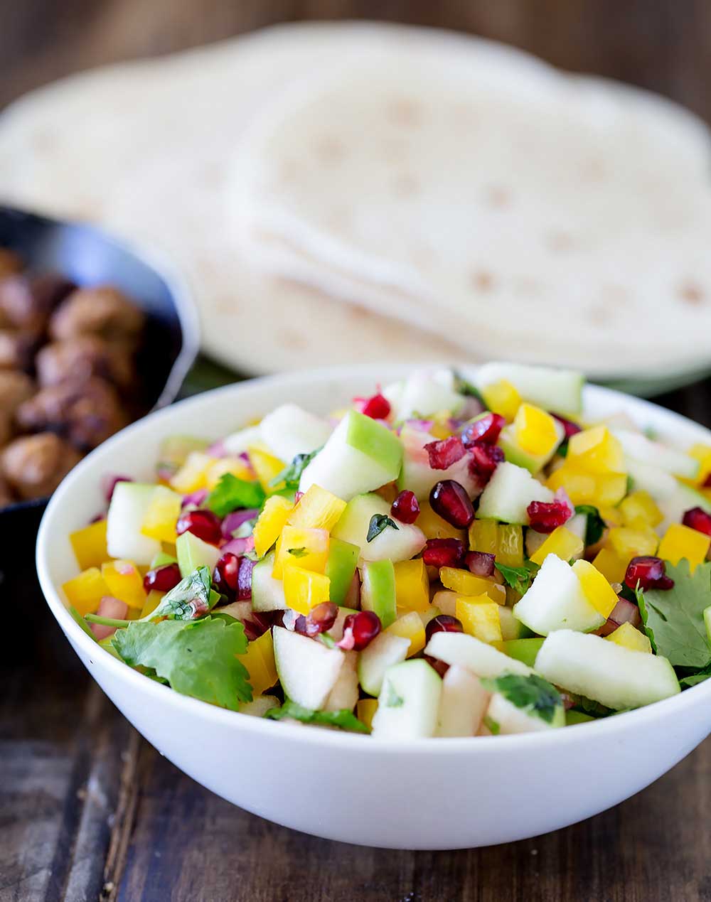 Crispy apple, the mild spice of red onion, sweet and sour pomegranate, the crunch of capsicum, flavourful and grassy coriander and the freshness of lime.