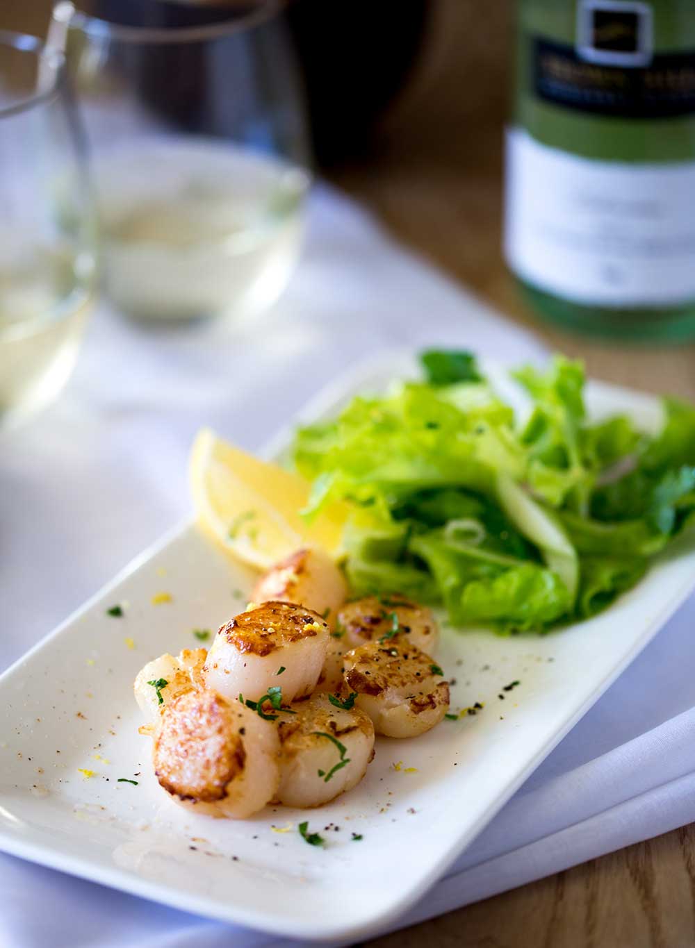 Firm buttery seared scallops, seasoned with lemon served with a fresh and crunchy apple and parsley salad with shallot dressing. | Sprinkles and Sprouts