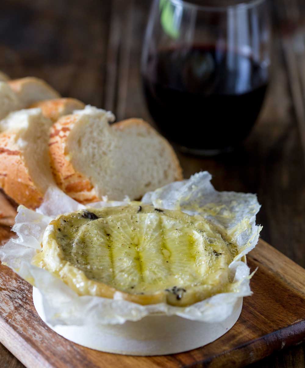 Creamy brie, enhanced with the earthy delicious flavours of black truffle all baked to oozing delicious perfection! Seriously this Baked Black Truffle Stuffed Brie is decadence and heaven on a plate!