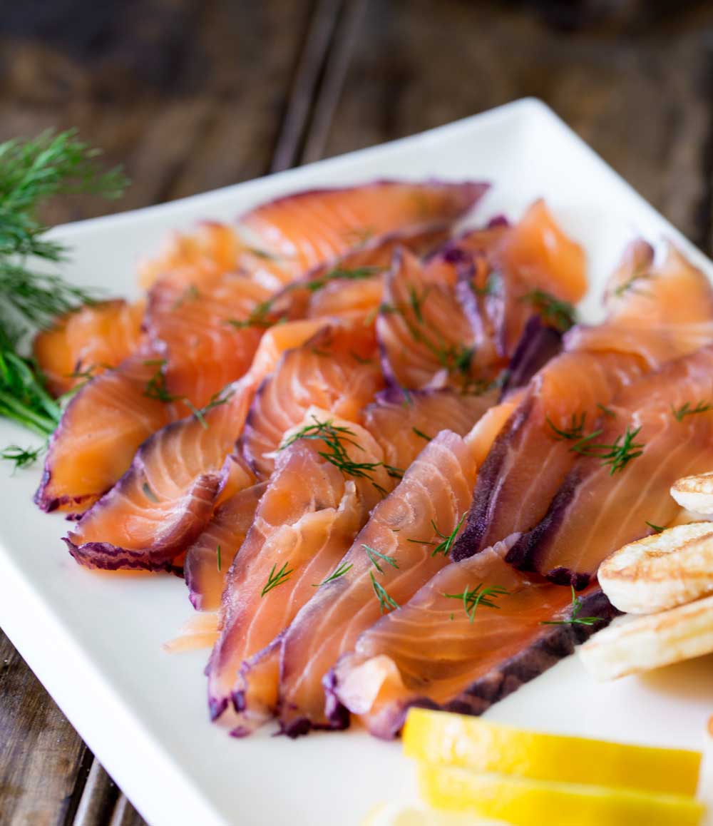 Home cured salmon. A delicious twist on a traditional gravlax. Fruity blueberries, spicy notes of dill and a salty sweet edge. This cured salmon is beautiful and delicious.