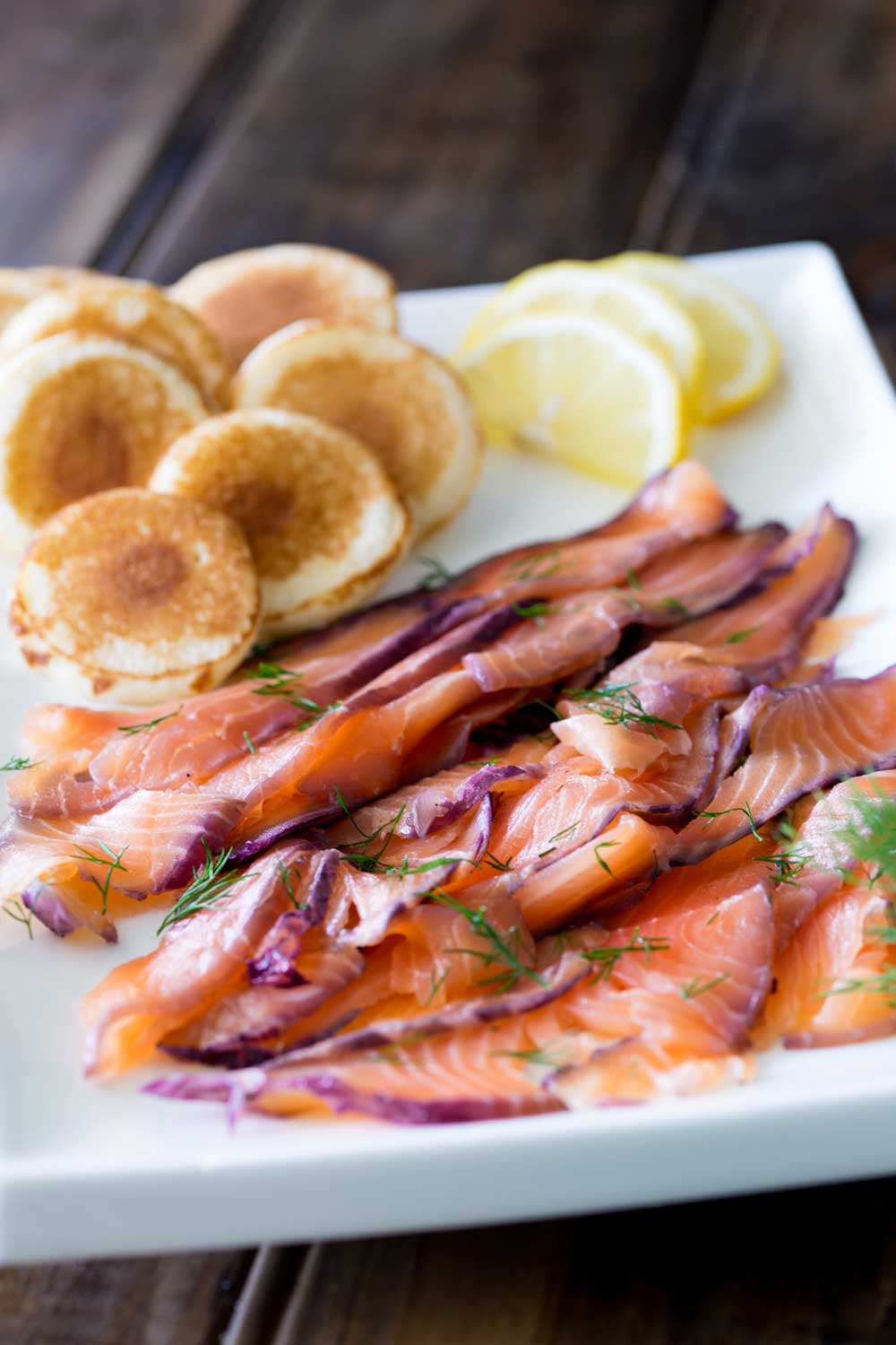Home cured salmon. A delicious twist on a traditional gravlax. Fruity blueberries, spicy notes of dill and a salty sweet edge. This cured salmon is beautiful and delicious.