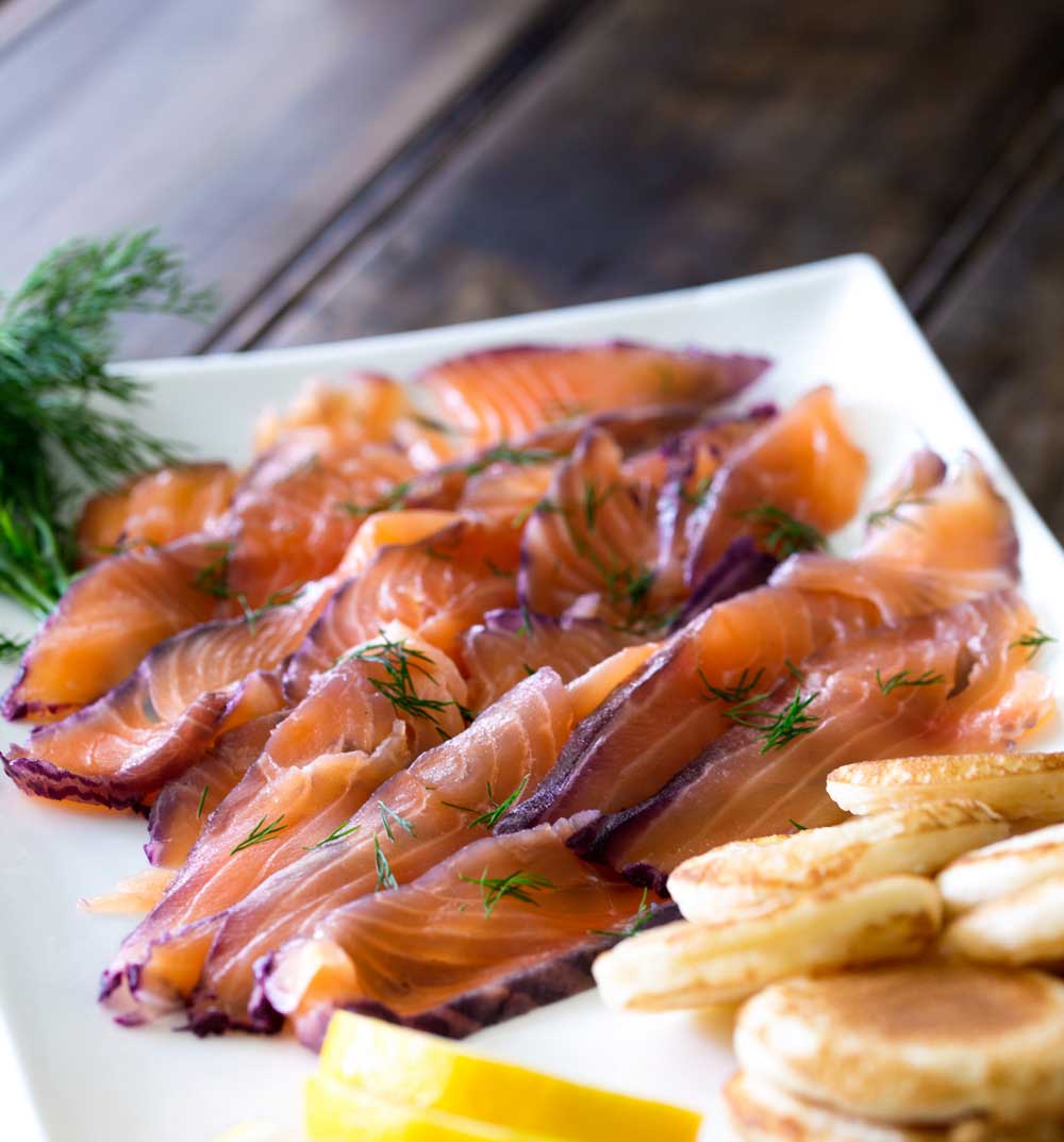 Home cured salmon. A delicious twist on a traditional gravlax. Fruity blueberries, spicy notes of dill and a salty sweet edge. This cured salmon is beautiful and delicious.