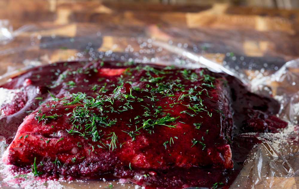 Home cured salmon. A delicious twist on a traditional gravlax. Fruity blueberries, spicy notes of dill and a salty sweet edge. This cured salmon is beautiful and delicious.