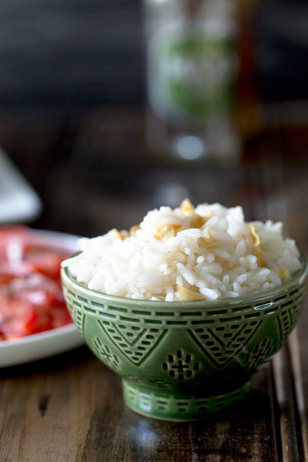 Brazilian White Rice is the perfect side dish, it is generously seasoned with onions and garlic. Turning a bowl of plain rice into something so so much more. | Sprinkles and Sprouts
