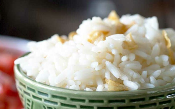 Brazilian White Rice is the perfect side dish, it is generously seasoned with onions and garlic. Turning a bowl of plain rice into something so so much more. | Sprinkles and Sprouts