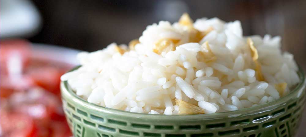 Brazilian White Rice is the perfect side dish, it is generously seasoned with onions and garlic. Turning a bowl of plain rice into something so so much more. | Sprinkles and Sprouts