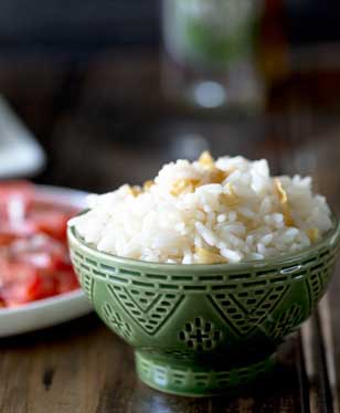 Brazilian White Rice is the perfect side dish, it is generously seasoned with onions and garlic. Turning a bowl of plain rice into something so so much more. | Sprinkles and Sprouts