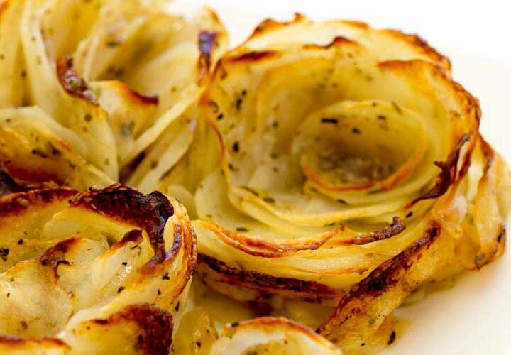 Soft, tender potato roses. Potatoes dressed with oodles of butter and arranged to be oh so so pretty. Seriously these look like a flower, even when they collapse they are super beautiful. Aren't they prittttttty!!!!