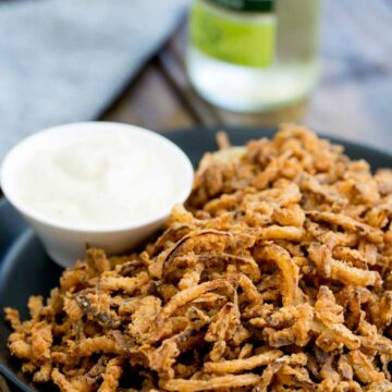 These crispy crunchy shoe string onions are so good! They taste sweet and crunchy with a background hint of salt and spice. I think I could eat a whole plateful myself! They are delicious as a snack or if you can resits eating them you could add them to a steak sandwich. Oh yes that is pure heaven!!!!!