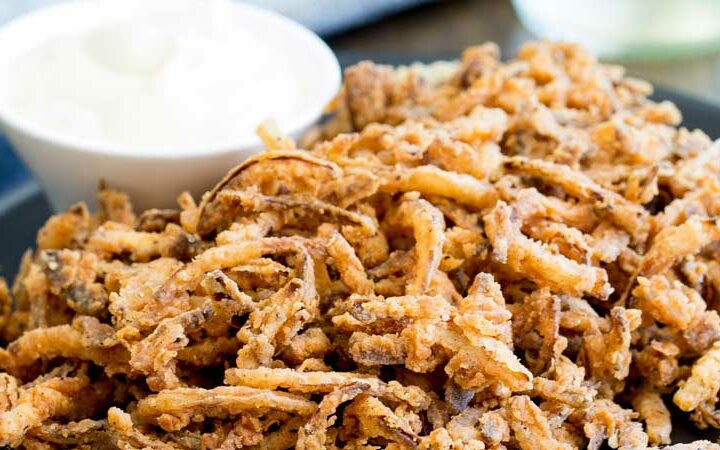 These crispy crunchy shoe string onions are so good! They taste sweet and crunchy with a background hint of salt and spice. I think I could eat a whole plateful myself! They are delicious as a snack or if you can resits eating them you could add them to a steak sandwich. Oh yes that is pure heaven!!!!!