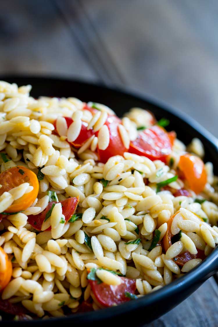 This Tomato Risoni Salad (Tomato Orzo Salad) is a super simple salad that is packed with flavour and works as a side or a main meal. You can add extra veg, meat, cheese what ever you fancy to this salad. It is delicious and perfect for summer or winter! 
