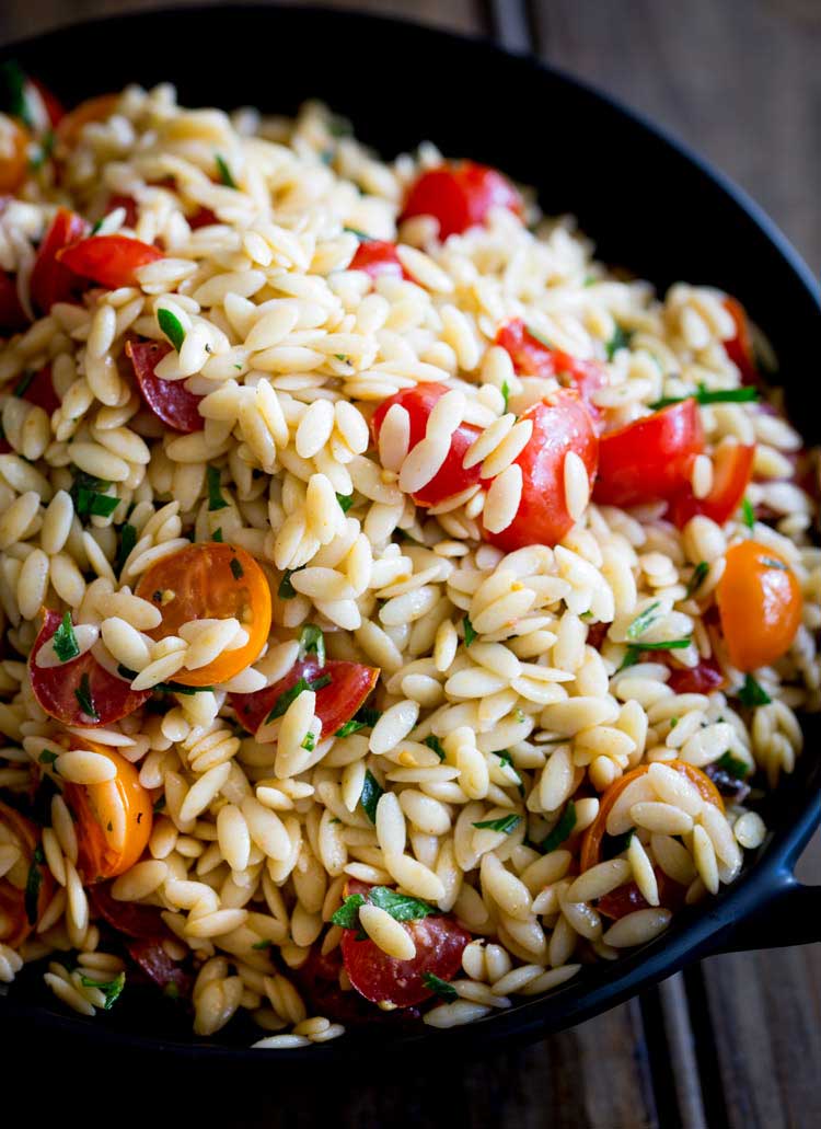 This Tomato Risoni Salad (Tomato Orzo Salad) is a super simple salad that is packed with flavour and works as a side or a main meal. You can add extra veg, meat, cheese what ever you fancy to this salad. It is delicious and perfect for summer or winter! 