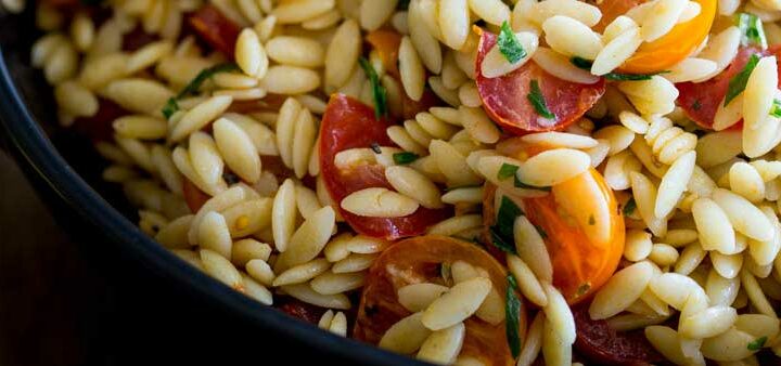 This Tomato Risoni Salad (Tomato Orzo Salad) is a super simple salad that is packed with flavour and works as a side or a main meal. You can add extra veg, meat, cheese what ever you fancy to this salad. It is delicious and perfect for summer or winter!